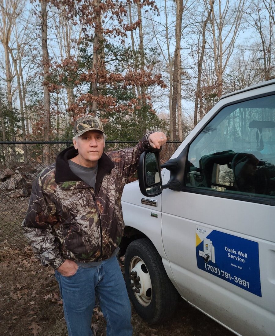 Ken Lindgren, founder of Oasis Well Service, by the company truck